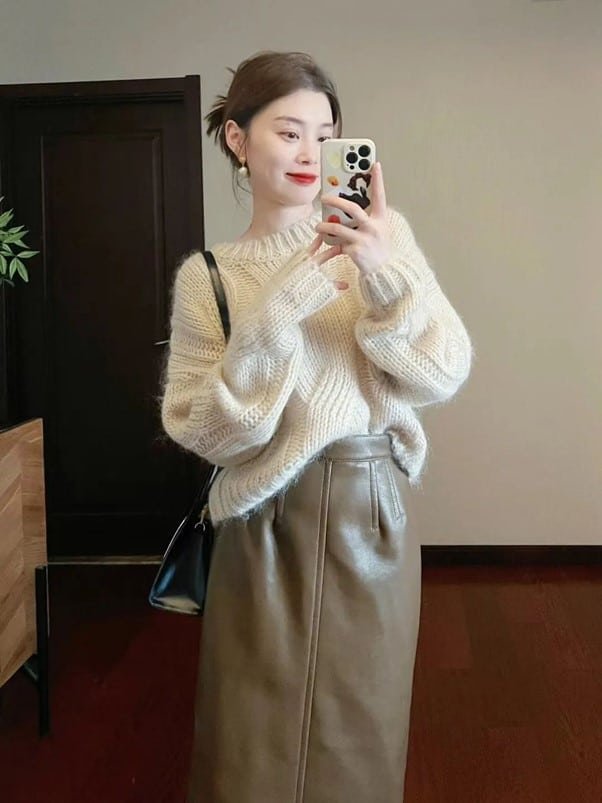 a sweater with a solid color long skirt